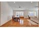 Spacious living room and dining room with abundant natural light from bay windows, wood floors at 1319 Highland Ct, Boulder City, NV 89005