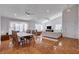 Bright, spacious living room with hardwood floors, large windows with plantation shutters, and a dining area at 1319 Highland Ct, Boulder City, NV 89005