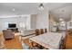 Open-concept living and dining area with vaulted ceilings, wood floors, and view into kitchen at 1319 Highland Ct, Boulder City, NV 89005