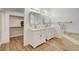 Bright main bathroom with double vanity, tile flooring, and walk-in closet access at 1319 Highland Ct, Boulder City, NV 89005