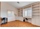 Well-lit office space with custom built-ins, a window bench, parquet floors and neutral walls at 1319 Highland Ct, Boulder City, NV 89005