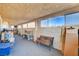 Bright sun room with lots of windows, bench seating, and carpeted floors offers a versatile space at 1319 Highland Ct, Boulder City, NV 89005