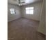 Bright bedroom with neutral carpeting, a ceiling fan, and a window providing natural light at 1540 Sabatini Dr, Henderson, NV 89052