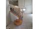 View of the entryway featuring a wooden staircase with decorative iron balusters and tile flooring at 1540 Sabatini Dr, Henderson, NV 89052