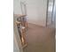 Upstairs hallway featuring neutral carpeting, a decorative railing, and access to bedrooms, creating a welcoming transition space at 1540 Sabatini Dr, Henderson, NV 89052