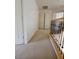Hallway with carpeted floors on the upper level, featuring a closet and stair railing at 1540 Sabatini Dr, Henderson, NV 89052