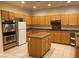 Bright kitchen featuring granite countertops, an island, tile flooring, and ample cabinet space at 1540 Sabatini Dr, Henderson, NV 89052