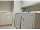 Bright laundry room with white cabinets and modern washer and dryer at 1540 Sabatini Dr, Henderson, NV 89052