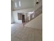 Bright living room with tile flooring, staircase, and large windows, creating a spacious and airy atmosphere at 1540 Sabatini Dr, Henderson, NV 89052