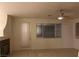 Living room with a fireplace, tile flooring, and a window providing ample natural light at 1540 Sabatini Dr, Henderson, NV 89052