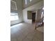 Open living room with tile flooring, high ceilings, and staircase, offering a seamless flow for entertaining and relaxing at 1540 Sabatini Dr, Henderson, NV 89052