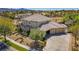 Spacious home featuring a three-car garage, desert landscaping, and a tile roof in an upscale community near a golf course at 165 Inveraray Ct, Henderson, NV 89074