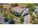 Aerial view of a luxurious home with a tile roof and swimming pool at 165 Inveraray Ct, Henderson, NV 89074