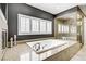Modern bathroom featuring a luxurious soaking tub and a glass-enclosed shower at 165 Inveraray Ct, Henderson, NV 89074