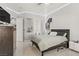 Bright bedroom featuring a cozy bed with unique headboard, tile floors, and stylish decor at 165 Inveraray Ct, Henderson, NV 89074