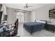 Bright bedroom with decorative window, ceiling fan, and marble-look tile floors at 165 Inveraray Ct, Henderson, NV 89074