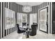 Bright breakfast nook features black and white striped walls, a modern chandelier, and shuttered windows at 165 Inveraray Ct, Henderson, NV 89074