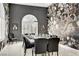 Sophisticated dining room with decorative wallpaper, modern chandelier, and seating for twelve at 165 Inveraray Ct, Henderson, NV 89074