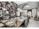 Dining area featuring a long table with place settings, floral wallpaper, and modern lighting at 165 Inveraray Ct, Henderson, NV 89074