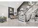 Grand entryway with a staircase featuring bold floral wallpaper, a pool table, and a striking fireplace at 165 Inveraray Ct, Henderson, NV 89074