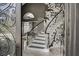 Elegant entryway featuring a staircase with black and white floral wallpaper and wrought iron accents at 165 Inveraray Ct, Henderson, NV 89074