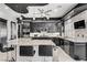 Modern kitchen features black cabinets, granite countertops, and stainless steel appliances at 165 Inveraray Ct, Henderson, NV 89074