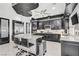 Sleek kitchen features black cabinetry, granite countertops, stainless steel appliances, and eat-in island at 165 Inveraray Ct, Henderson, NV 89074