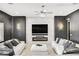 Living room featuring a fireplace, a large TV, two plush sofas, and decorative lighting at 165 Inveraray Ct, Henderson, NV 89074