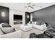 Spacious living room with fireplace, modern lighting, plush seating, and accent wall at 165 Inveraray Ct, Henderson, NV 89074