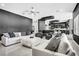 Bright and modern living room with designer furniture, a view of the kitchen and tiled flooring at 165 Inveraray Ct, Henderson, NV 89074