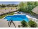 Backyard pool area with spa, lounge area, and view of the golf course. Perfect for entertaining and relaxation at 165 Inveraray Ct, Henderson, NV 89074