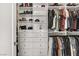 Organized walk-in closet with custom shelving and ample storage for clothes and shoes at 165 Inveraray Ct, Henderson, NV 89074