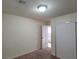 Carpeted bedroom with closet, overhead lighting, and access to the hallway at 1673 Caliente Ct, Las Vegas, NV 89119