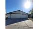 Exterior front view of a home with a two-car garage and wide driveway on a sunny day at 1673 Caliente Ct, Las Vegas, NV 89119