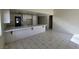 Spacious kitchen with white cabinets, a long tile countertop, and tile floors at 1673 Caliente Ct, Las Vegas, NV 89119
