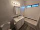 Cozy bathroom with a vanity, sink, mirror, lighting, and a bathtub with tiled walls at 2011 Sue Ct # 203, Las Vegas, NV 89108