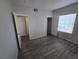 A well-lit bedroom with hardwood floors and multiple windows allowing for plenty of natural light at 2011 Sue Ct # 203, Las Vegas, NV 89108