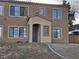 Two story tan home with stucco, many windows and a covered front porch at 2011 Sue Ct # 203, Las Vegas, NV 89108