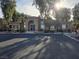 Community clubhouse featuring an arched entryway, desert landscaping, and ample parking at 2011 Sue Ct # 203, Las Vegas, NV 89108