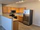 Kitchen features stainless steel appliances, wooden cabinetry, and breakfast bar at 2011 Sue Ct # 203, Las Vegas, NV 89108