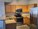 Kitchen features modern appliances, wooden cabinetry and eat-in bar at 2011 Sue Ct # 203, Las Vegas, NV 89108