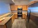 Modern kitchen featuring stainless steel appliances, wood cabinets, and a breakfast bar at 2011 Sue Ct # 203, Las Vegas, NV 89108