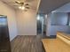 Open concept living and kitchen area with modern flooring, stainless appliances, and a ceiling fan at 2011 Sue Ct # 203, Las Vegas, NV 89108
