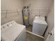 A laundry room with a washer, dryer, water heater, and wire shelving for storage at 2011 Sue Ct # 203, Las Vegas, NV 89108