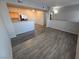 Open-concept living and dining area with new plank flooring and updated fixtures at 2011 Sue Ct # 203, Las Vegas, NV 89108