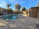 A community pool with lush landscaping and a clear blue sky overhead at 2011 Sue Ct # 203, Las Vegas, NV 89108