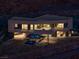 Aerial view of a modern home with a luxurious pool, sleek design and landscape lighting at 21 Rockstream Dr, Henderson, NV 89012