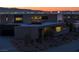 Striking modern home showcasing desert landscaping and illuminated facade, creating a welcoming nighttime ambiance at 21 Rockstream Dr, Henderson, NV 89012