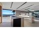 Modern kitchen with dark countertops and a connected island-dining space overlooking a scenic view at 21 Rockstream Dr, Henderson, NV 89012