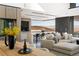 Open concept living room with a cozy sofa, wine cellar and a beautiful view at 21 Rockstream Dr, Henderson, NV 89012